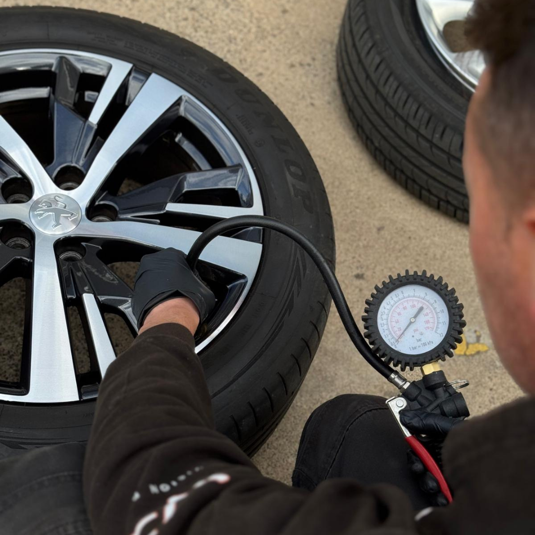 Peugeot diamond cut alloy back on the car — tyre pressure check on the driveway