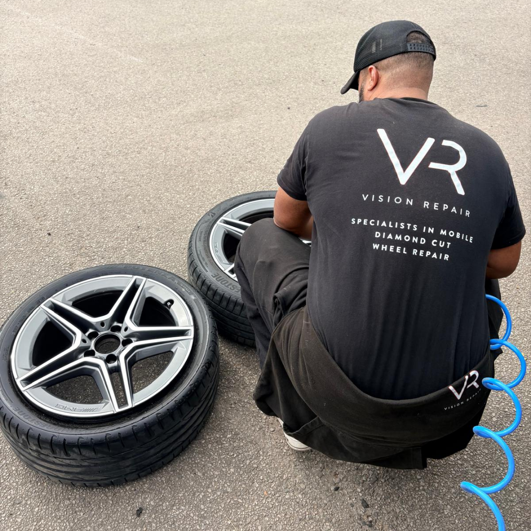 Vision Repair technician working on diamond cut alloy wheels at a mobile repair