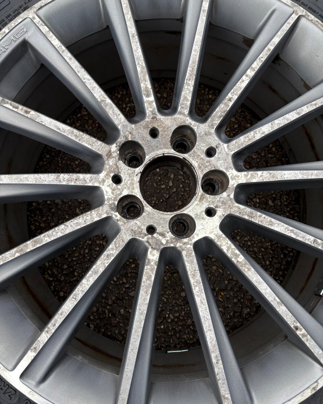 Mercedes-AMG alloy wheel before refurbishment — corroded and kerbed